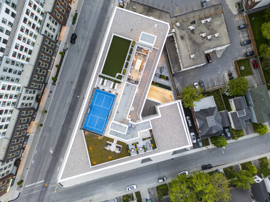 Overhead view of GEOpark rooftop amenities, including a pool, sport court, and landscaped terraces.